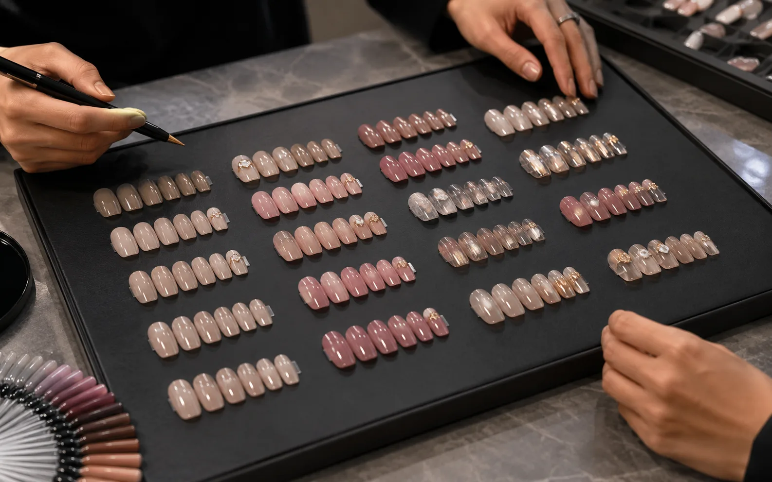 Sample revision review with updated nail design options and packaging adjustments